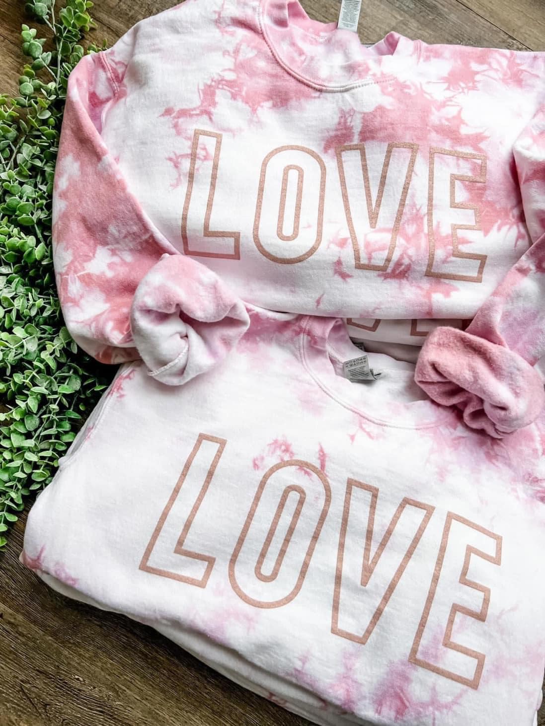 pink sweater that says "LOVE"